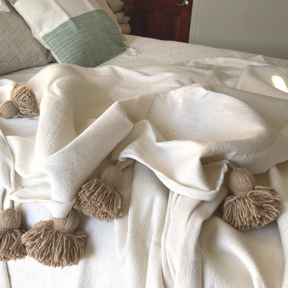 Blanket with pom poms deals